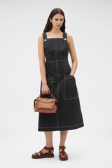 Profile view of model wearing the Oroton Pocket Detail Dress in Washed Black and 100% cotton canvas fabric for Women .