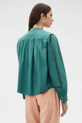 Profile view of model wearing the Oroton Picnic Blouse in Bistro Green and 100% cotton poplin fabric for Women .