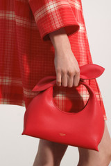 Profile view of model wearing the Oroton Myrtle Mini Bag in Market Red and Premium smooth leather for Women .