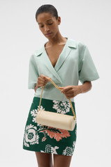 Profile view of model wearing the Oroton Romy Barrel Bag in Honey Peach and Premium smooth leather for Women .
