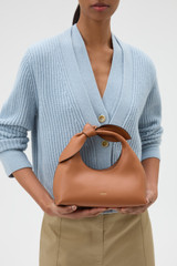 Profile view of model wearing the Oroton Myrtle Mini Bag in Cognac and Premium smooth leather for Women .