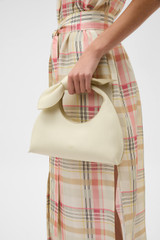 Profile view of model wearing the Oroton Myrtle Mini Bag in Vanilla Bean and Premium smooth leather for Women .