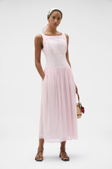 Profile view of model wearing the Oroton Yoke Detail Sundress in Rose and 100% lightweight semi-sheer cotton voile fabric for Women .