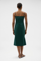 Profile view of model wearing the Oroton Knot Detail Dress in Helm Green and 100% cotton poplin fabric for Women .