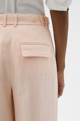 Profile view of model wearing the Oroton Flat Front Pant in Nougat and 100% heavy linen fabric for Women .