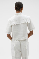 Profile view of model wearing the Oroton Handkerchief Camp Shirt in Antique White and 100% mid-weight linen fabric for Women .