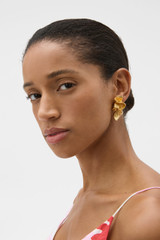 Profile view of model wearing the Oroton Coral Large Stud in Worn Gold and Brass base for Women .
