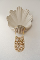 Profile view of model wearing the Oroton Vera Luxe Bead Bag in Pearl and 18k worn gold mesh body for Women .