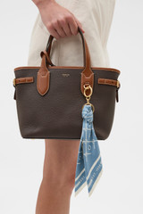 Profile view of model wearing the Oroton Eve Scarf Keyring in Sky Blue/Cream and 100% polyester fabric for Women .
