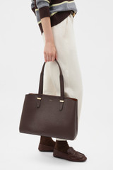 Profile view of model wearing the Oroton Anika 13" Day Bag in Coffee Bean and  for Women .