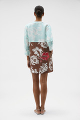 Profile view of model wearing the Oroton Cabana Floral Tunic Dress in Glass/Chocolate and 100% silk dupion fabric for Women .