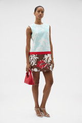 Profile view of model wearing the Oroton Cabana Floral Mini Dress in Glass and 100% silk dupion fabric for Women .