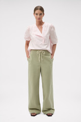 Profile view of model wearing the Oroton Weekend Pull On Pant in Soft Sage and 100% cotton fabric for Women .
