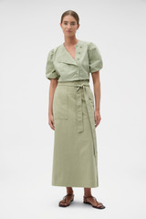 Profile view of model wearing the Oroton Snap Detail Skirt in Soft Sage and 100% cotton fabric for Women .