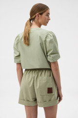 Profile view of model wearing the Oroton Weekend Short in Soft Sage and 100% cotton fabric for Women .