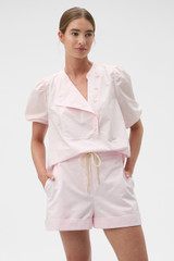 Profile view of model wearing the Oroton Weekend Short in Palest Pink and 100% cotton fabric for Women .