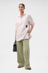 Profile view of model wearing the Oroton Snap Detail Tunic in Palest Pink and 100% cotton twill fabric for Women .