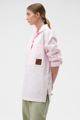 Profile view of model wearing the Oroton Snap Detail Tunic in Palest Pink and 100% cotton twill fabric for Women .