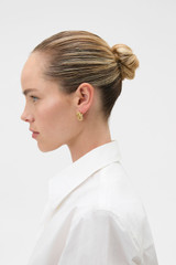 Profile view of model wearing the Oroton Nora Rope Large Studs in Gold and Premium brass material for Women .
