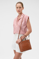 Profile view of model wearing the Oroton Polly Perforated Small Tote in Cognac and Premium smooth leather for Women .