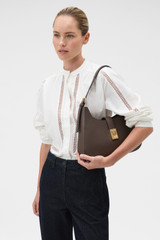 Profile view of model wearing the Oroton Yvonne Large Baguette in Coffee Bean and Premium pebble leather for Women .