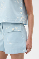 Profile view of model wearing the Oroton Seabird Short in Seaside Blue and 50% cotton and 50% linen blend fabric for Women .