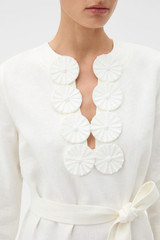Profile view of model wearing the Oroton Embellished Short Tunic Dress in Antique White and 100% cotton poplin material for Women .
