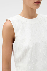 Profile view of model wearing the Oroton Tassel Lace Top in White and 45% viscose, 30% rayon, and 25% linen blend fabric for Women .