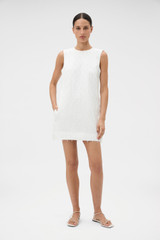 Profile view of model wearing the Oroton Tassel Lace Shift Dress in White and 45% viscose, 30% rayon, and 25% linen blend fabric for Women .