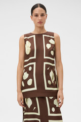 Profile view of model wearing the Oroton Graphic Shell Tunic in Dark Chocolate and 100% silk twill fabric for Women .
