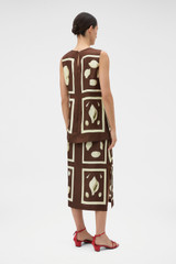 Profile view of model wearing the Oroton Graphic Shell Slip Skirt in Dark Chocolate and 100% silk twill fabric for Women .