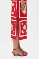 Profile view of model wearing the Oroton Graphic Shell Slip Skirt in Ribbon Red and 100% silk twill fabric for Women .