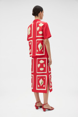 Profile view of model wearing the Oroton Graphic Shell Slip Skirt in Ribbon Red and 100% silk twill fabric for Women .