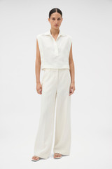 Profile view of model wearing the Oroton Flat Front Pant in Soft Cream and 100% heavy linen fabric for Women .