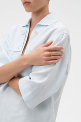 Profile view of model wearing the Oroton Aurie Ring in Gold and Premium brass material for Women .