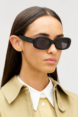 Profile view of model wearing the Oroton Rumi Sunglasses in Black and Acetate material for Women .