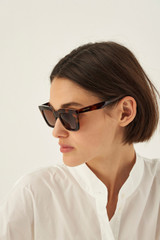 Profile view of model wearing the Oroton Astrid Sunglasses in Tort and Acetate material for Women .