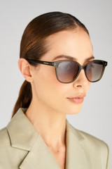 Profile view of model wearing the Oroton Dylan Sunglasses in Fern Khaki and Premium acetate material for Women .