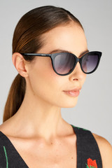 Profile view of model wearing the Oroton Reid Sunglasses in Black and Premium acetate material for Women