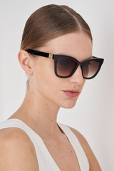 Profile view of model wearing the Oroton Frankie Sunglasses in Black and Premium acetate material for Women .