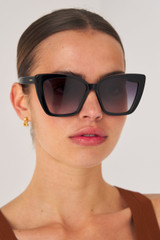 Profile view of model wearing the Oroton Jamie Sunglasses in Black and Acetate material for Women .
