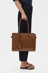 Profile view of model wearing the Oroton Grace 14" Work Bag in Cinnamon and Premium Saffiano leather body for Women .