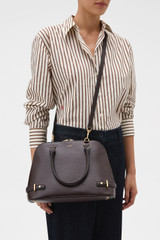 Profile view of model wearing the Oroton Grace Grip Top in Burnt Umber and Premium Saffiano leather body for Women .