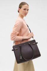 Profile view of model wearing the Oroton Grace 14" Work Bag in Burnt Umber and Premium Saffiano leather body for Women .
