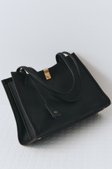 Profile view of model wearing the Oroton Mille Work Tote in Black and Premium pebble leather for Women .