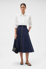 Profile view of model wearing the Oroton Stitch Detail Shirt in White and 100% linen fabric for Women .