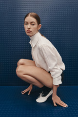 Profile view of model wearing the Oroton Stitch Detail Shirt in White and 100% linen fabric for Women .