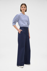 Profile view of model wearing the Oroton Flat Front Wide Leg Pant in North Sea and 100% cotton fabric for Women .