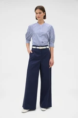 Profile view of model wearing the Oroton Flat Front Wide Leg Pant in North Sea and 100% cotton fabric for Women .