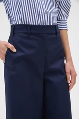 Profile view of model wearing the Oroton Flat Front Wide Leg Pant in North Sea and 100% cotton fabric for Women .